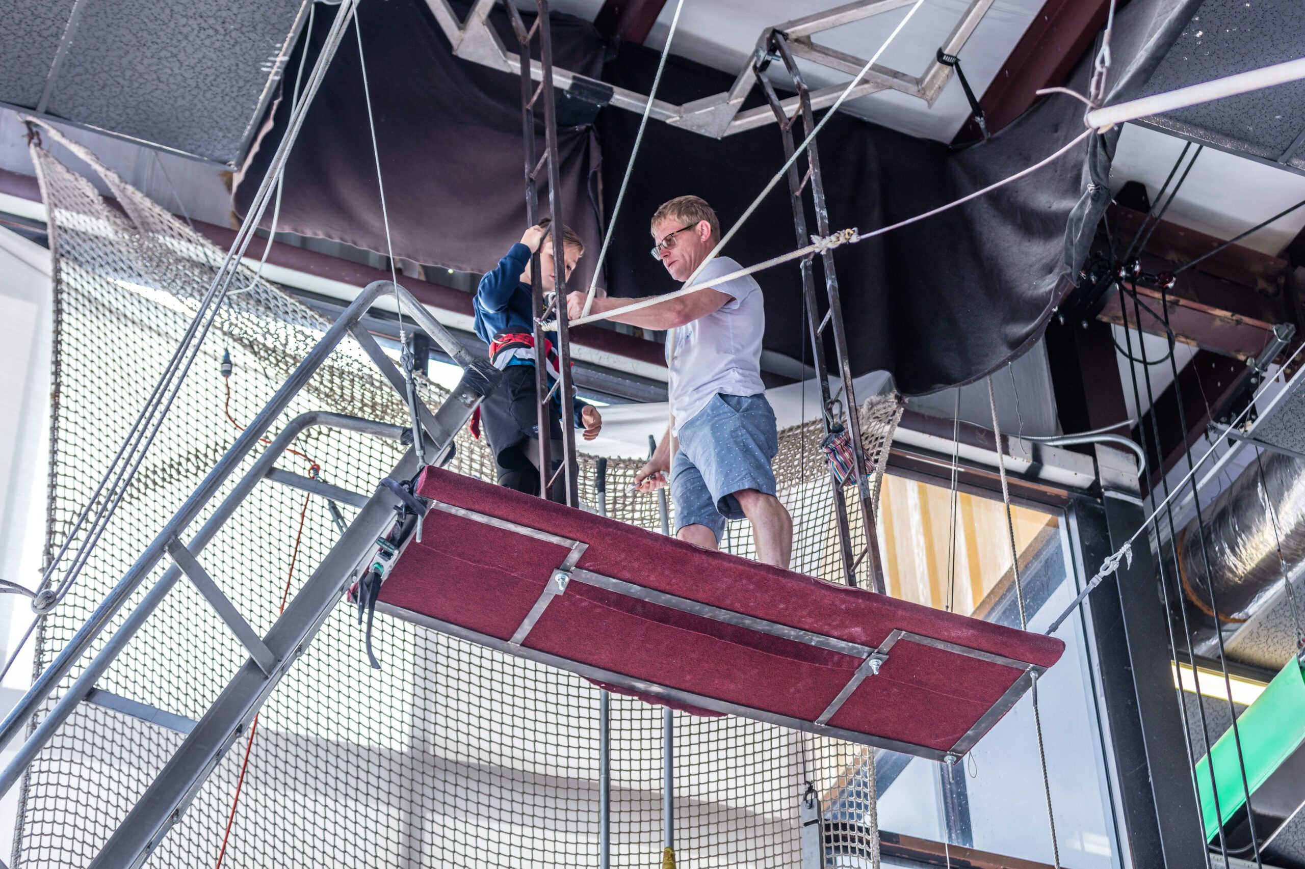 Coach demonstrating aerial technique at Orlando Circus School