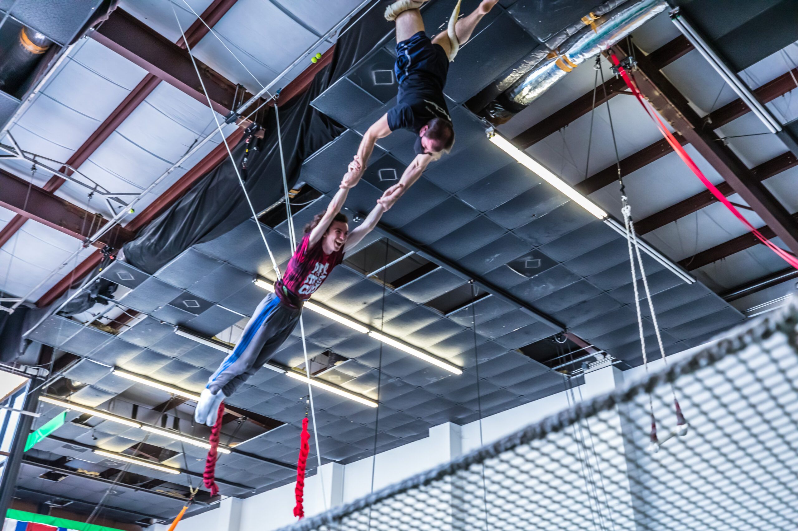 Flyer swinging over the safety net on the flying trapeze
